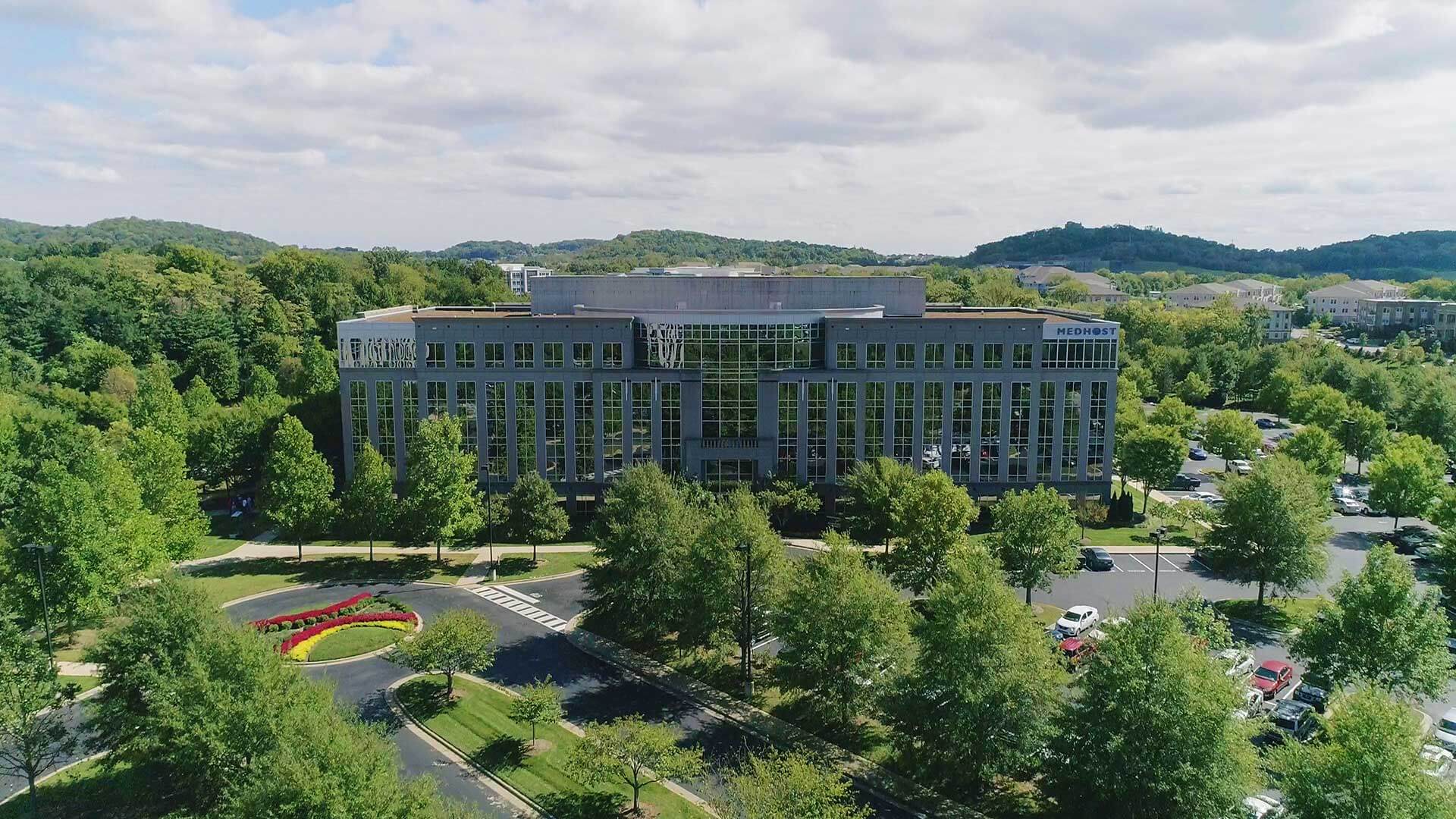 Medhost modern building with green area.